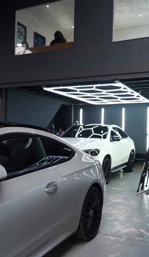 Structural steel mezzanine floor with insulated office units and glazed doors above a car showroom in Milton Keynes
